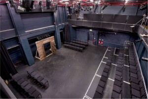 View of the Ron Barber Studio from above. The stage is bare and the seating is in thrust layout, with seating on three sides of the acting area.